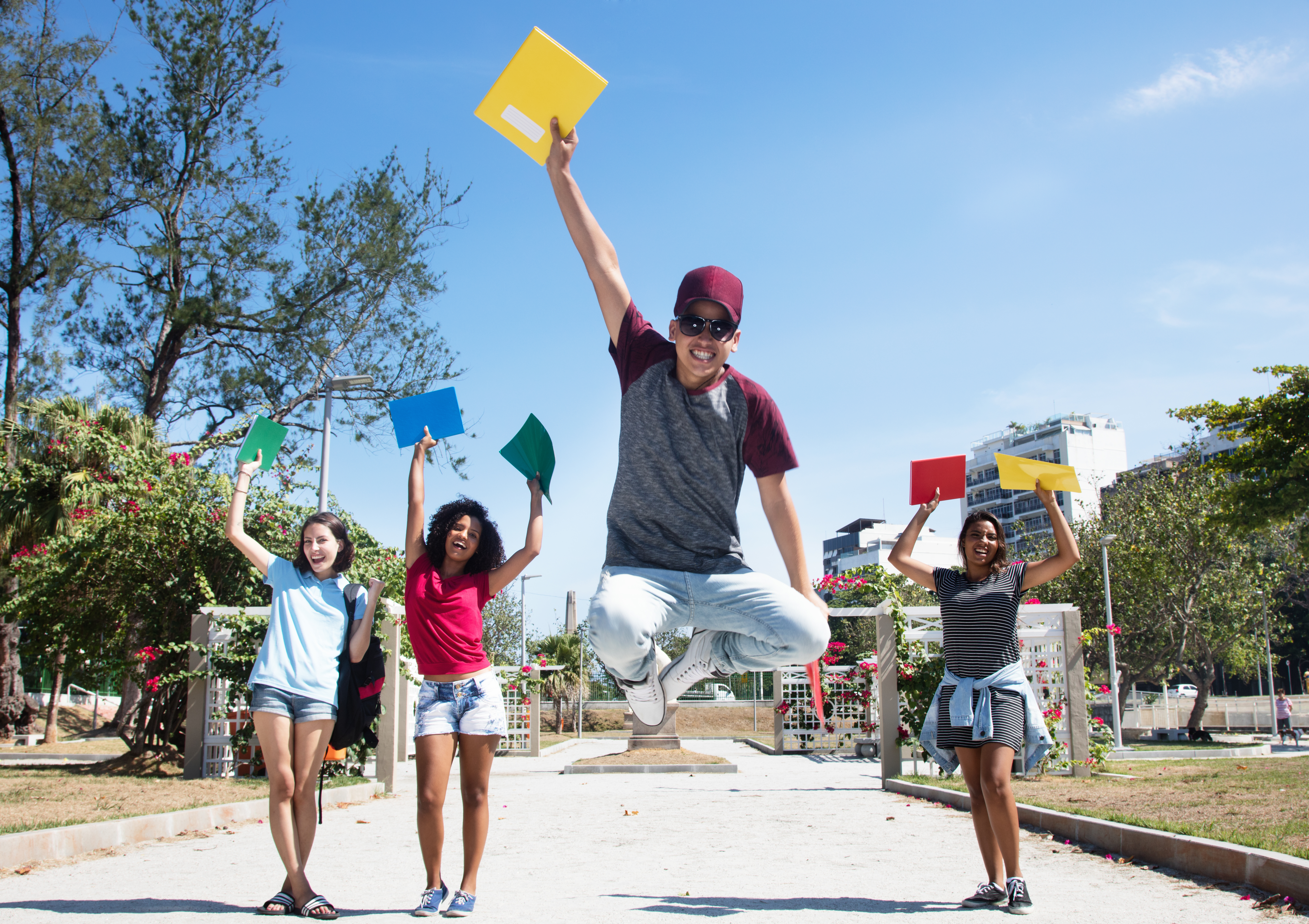 Group of successful students cheering in city