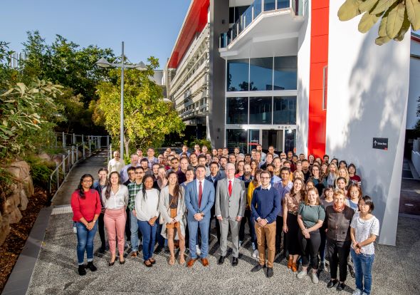Photo of large group of staff who work for the Institute of Glycomics standing in front the Institute for Glycomics building