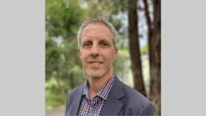 Profile photo of Nicholas Charlton. He is smiling and looking at the camera.